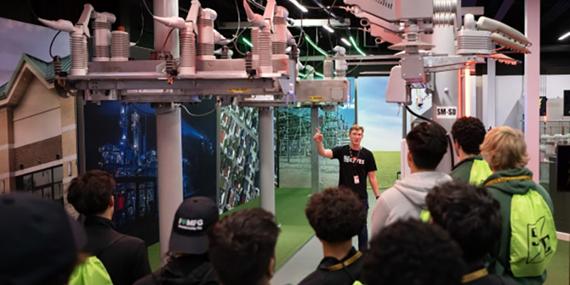 S&C team member hosting a tour of S&C's Product Demonstration Center for a group of students.