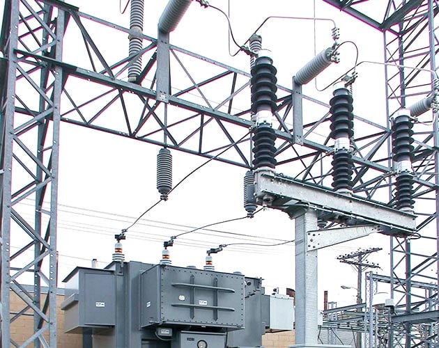 Trans Rupter II Transformer Protector installed in a substation with gray skies above Trans-Rupter II Transformer Protector, transformer protector, overhead switchgear, distributions