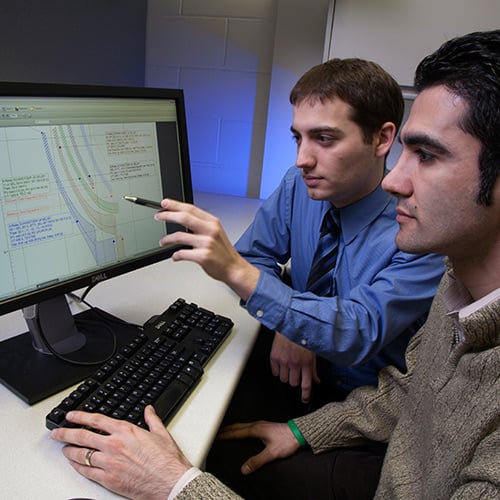 Engineering Services, team members working together, working in front of a computer, tcc curve, tcc curve on a computer monitor